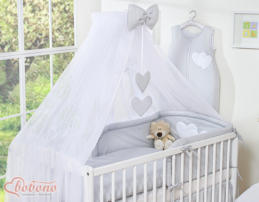 Large mosquito net for baby's bed made of white chiffon with hanging hearts and a bow - gray hangers