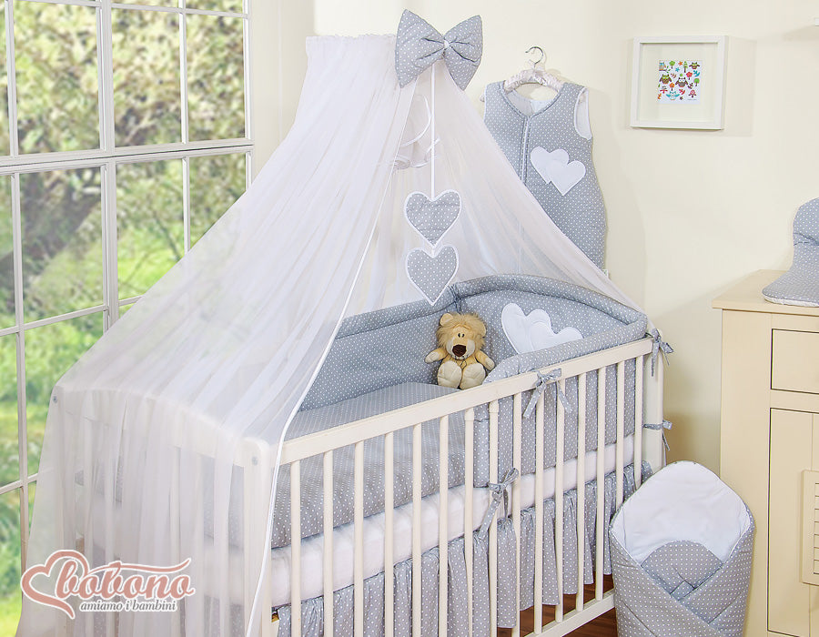 Large mosquito net for baby's bed made of white chiffon with hanging hearts and a bow - dots on gray