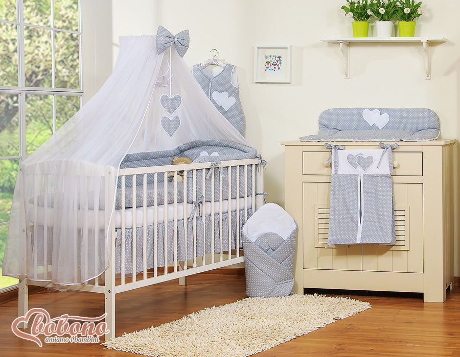 Large mosquito net for baby's bed made of white chiffon with hanging hearts and a bow - dots on gray