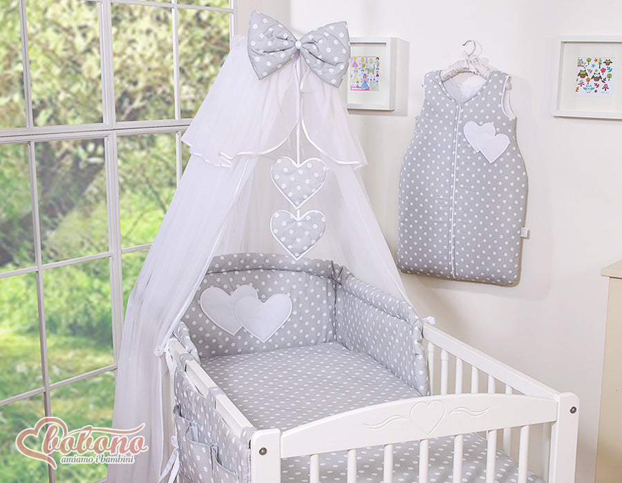 Large mosquito net for baby's bed made of white chiffon with hanging hearts and a bow - dots on gray