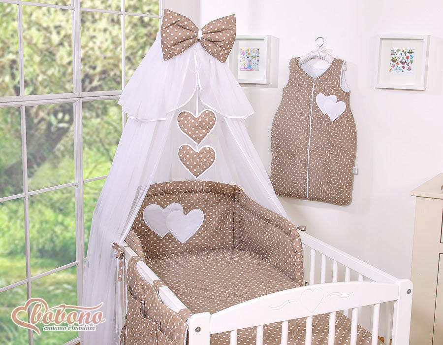 Large mosquito net for baby's bed made of white chiffon with hanging hearts and a bow -dots on brown