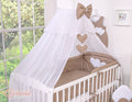 Large mosquito net for baby's bed made of white chiffon with hanging hearts and a bow -dots on brown