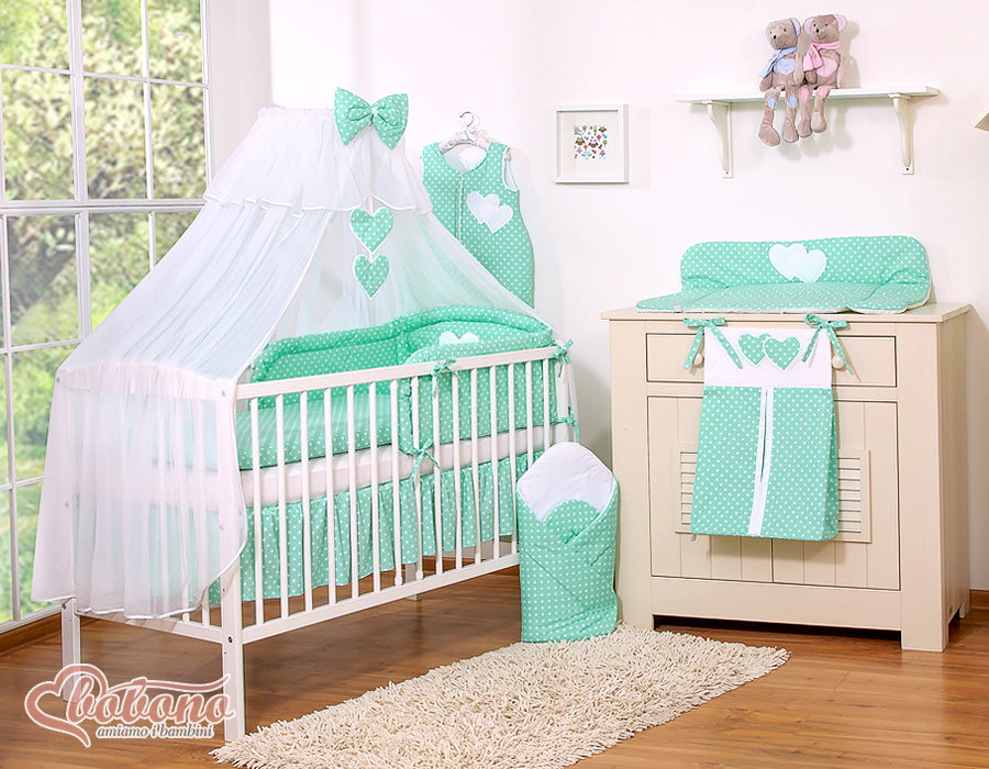 Large mosquito net for baby's bed made of white chiffon with hanging hearts and a bow - dots on mint